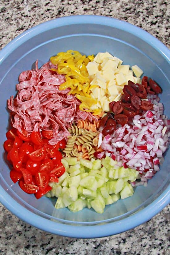 Overnight Pasta Salad is bursting with a rainbow of flavors, then topped with a favorite Italian dressing.