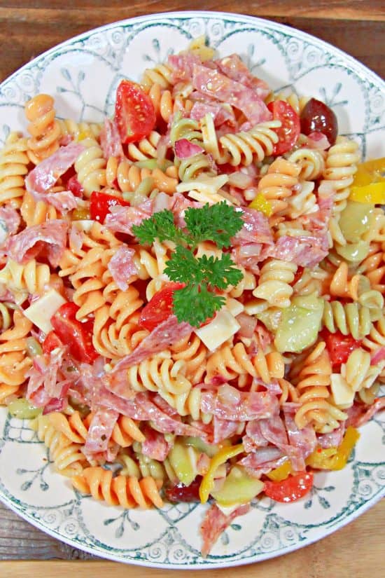 Rotini surrounded by cucumber, Kalamata olives, salami, and tomatoes with a delicious Italian dressing.