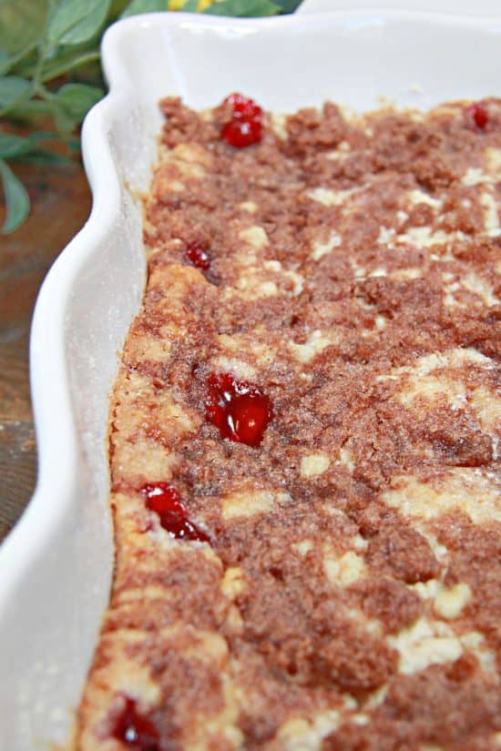 Sweet, delicious cherry pie filling pokes through the cracks of a layered cake mix.