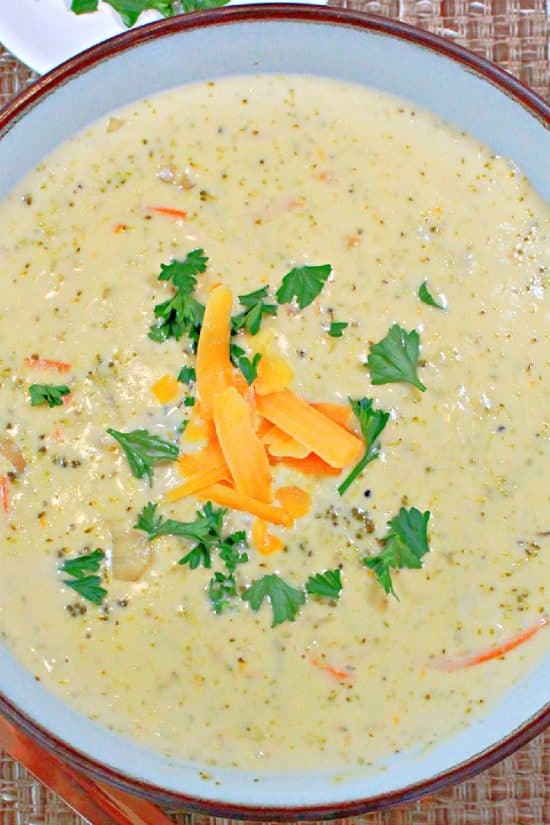Shredded cheddar cheese and fresh chopped parsley on a hearty soup made with fresh vegies and Velveeta.