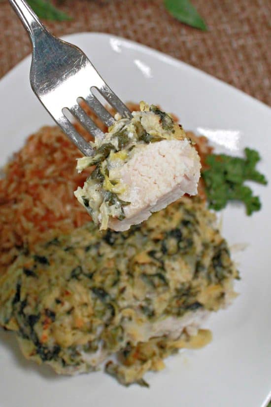 A bite of tender baked white meat coated in a tasty, delicious topping.