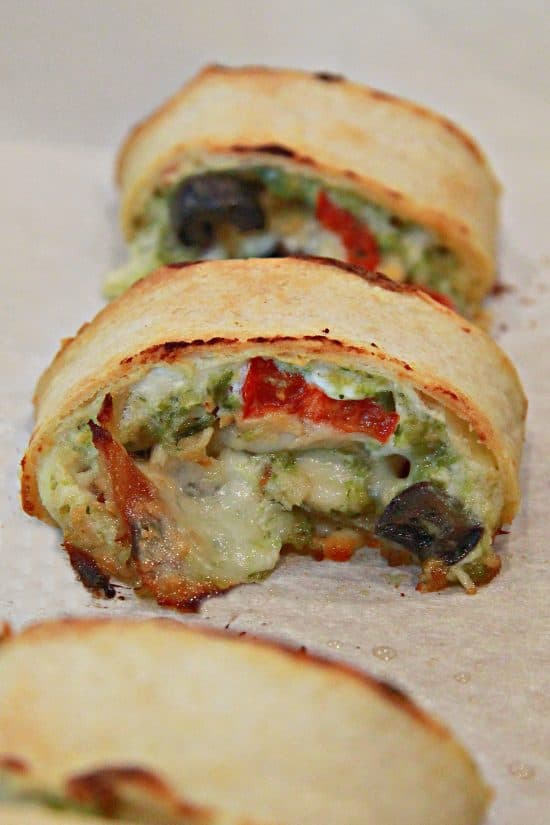 A tortilla wrapped dish with cheese, pesto, cream cheese, and your favorite toppings.