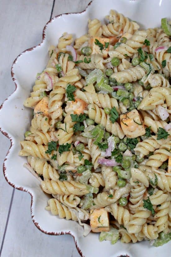 Cubes of cheese, crisp slices of veggies, and tender rotini covered in a tangy dressing.