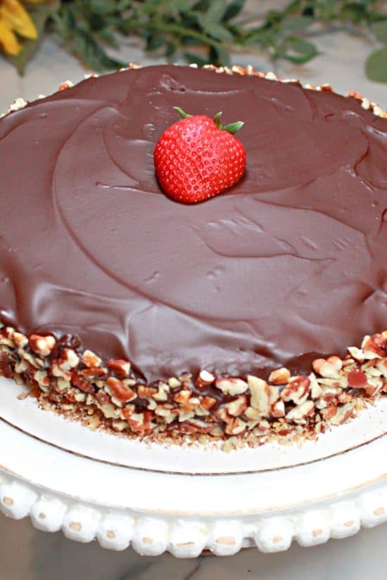 A deep, rich chocolate glaze covers this gluten-free dessert with toasted pecans.