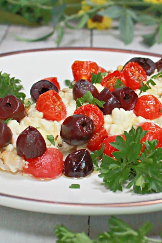 Kalamata olives, feta cheese, and cherry tomatoes top a moist chicken dish made easily in the oven.